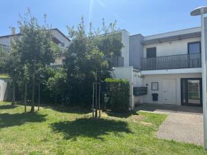 two trees in a yard in front of a building at Résidence Perspectives Océanes in Anglet