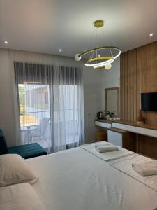 a bedroom with a large white bed and a window at Apartments Dolcinium in Donji Štoj