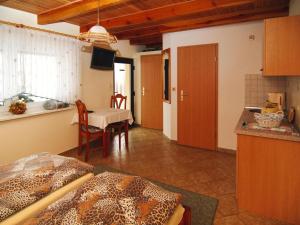a room with a kitchen and a dining room with a table at Bungalow in Lübben with a terrace in Lübben