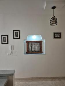 a room with a white wall with a stove on it at Cozy Apartment in Monastir