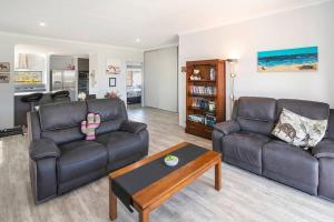 a living room with two couches and a coffee table at The Foxes Den- secure yard, WIFI in Geographe