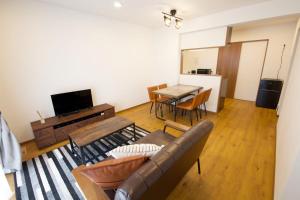 a living room with a couch and a table at Value Residence下地上地2 A棟 in Miyako Island