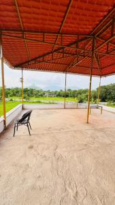 a bench sitting under a pavilion with a large roof at RKS- The Studio Farm in Valap