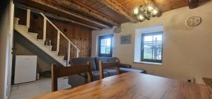 a room with a table and chairs and a staircase at Vacation House Viskic in Supetarska Draga +8 photos