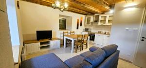 a living room with a blue couch and a kitchen at Vacation House Viskic in Supetarska Draga