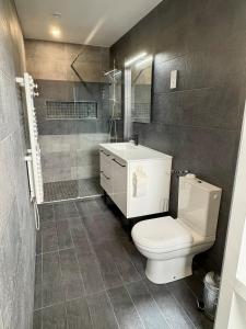a bathroom with a white toilet and a sink at Un havre de Paix entre Paris et Disney in Le Plessis-Trévise +35 photos