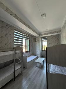 a room with two bunk beds and a table at Chorsu Old City in Tashkent +11 photos