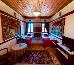 a living room with a couch and a table at Meliteion Traditional Hotel in Asprangeloi