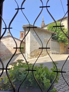 a view through a window of a building at La casetta della nonna in Camagna Monferrato +12 photos