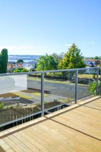 a metal railing on a deck with a view of a street at Richmond Heights apartment in Taupo