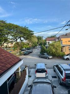 a street with cars parked in a parking lot at Homestay Rumah Kolek, Shah Alam in Shah Alam +32 photos