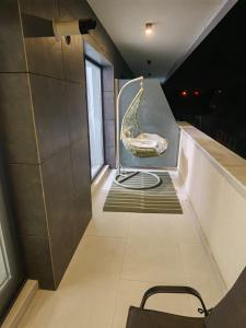 a room with a staircase with a chair in it at Alezzi Odyssey in Mamaia Nord
