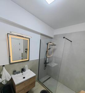 a bathroom with a sink and a shower at Alezzi Odyssey in Mamaia Nord