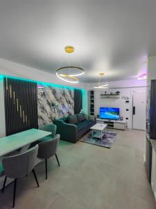 a living room with a couch and a table at Alezzi Odyssey in Mamaia Nord