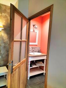 a bathroom with a sink and a mirror at Les Chambres de Saint Hilaire in Saint-Hilaire-Cottes