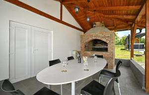 a white table and chairs in a room with a fireplace at Vila Roza in Husinec