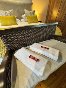 two towels sitting on top of two beds at The Whispering Milkwood Cottage in Gqeberha