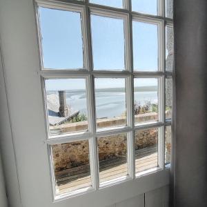 a window with a view of the ocean at Chez Adèle in Le Mont Saint Michel