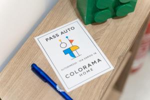 a sign on a wooden table with a pen at Colorama Home in Catania