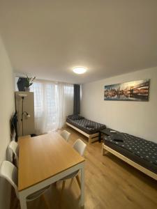 a living room with a table and a couch at Rooms in Warsaw - G39 in Warsaw