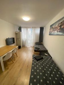 a room with a bed and a table and a desk at Rooms in Warsaw - G39 in Warsaw