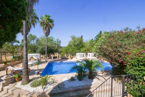a swimming pool in a yard with trees and flowers at FALCO , Apartment auf Finca Zenara, Terrasse, XXL-Pool, Küche, AC, WIFI, Yoga in Manacor