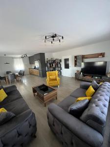 a living room with two couches and a table at Villa Star Lux Bijeljina in Bijeljina