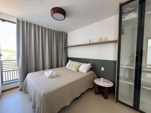 Postel nebo postele na pokoji v ubytování Condominio Frente Mar 3 suites com Ar Cond piscina e Hidro privativa + 66 fotografií