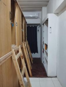 a row of chairs sitting in a room with a hallway at Capsule bed in Manila