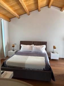 a bedroom with a large bed with two night stands at Locanda di Ody in Pietra Montecorvino +8 photos