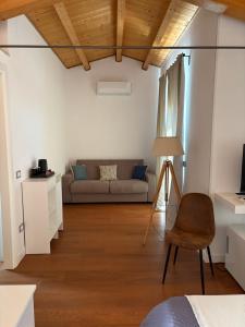 a living room with a couch and a chair at Locanda di Ody in Pietra Montecorvino