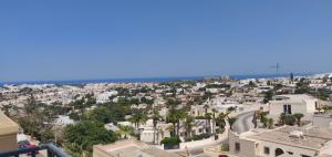 an aerial view of a city with houses and the ocean at Comfortable vacation home with great views in Mellieħa