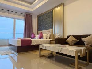 a bedroom with a king sized bed and a couch at High Tides End Ceylon Negombo in Negombo +10 photos