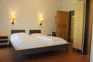 a bed in a room with two lights on the wall at Chalet Rehlein in Grossarl