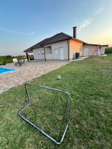 a net on the grass in front of a house at Villa Star Lux Bijeljina in Bijeljina