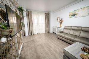 a living room with a couch and a table at Natural Luxury Studio Central Adress Residence in Bucharest