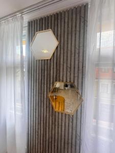 a room with a table on a wall with curtains at Apartament Wszystkie Gwiazdy Kopernika in Toruń +24 photos