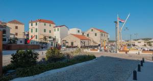 a group of buildings in a city with a street at Marica - Studio Apartment in Betina