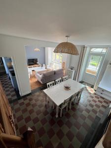 a living room with a couch and a table at LA MAISON DE CECILE jusqu'à 6 personnes en Normandie in Condé-sur-Vire