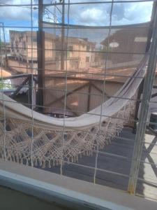 a hammock hanging from a window in a building at Spacious COP 30 home - Casa espaçosa COP 30 in Belém