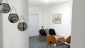 a dining room with chairs and a table and mirrors at TRIUMPH rooms and apartment in Vlorë +5 photos