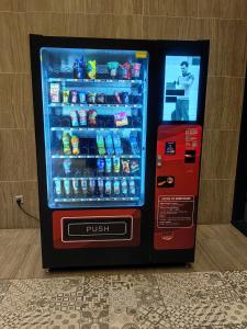 a vending machine with drinks and a drink cooler at Wonderful Geo Bukit Rimau Condominium in Shah Alam