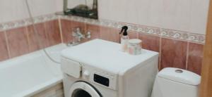 a washing machine in a bathroom with a sink at Квартира 2х-комнатная посуточно in Kryvyi Rih