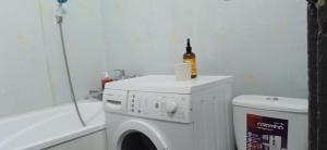 a bathroom with a washing machine with a bottle on it at Квартира 2х-комнатная посуточно in Kryvyi Rih +4 photos