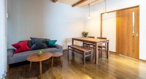 a living room with a couch and a table at CoCo Town Goryu in Hakuba