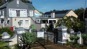 a house with solar panels on the roof at Tsitsikamma Mountain View Lodge in Stormsrivier