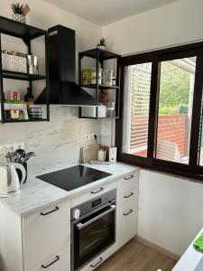 a kitchen with a sink and a stove top oven at Beachfront house in Preko +7 photos
