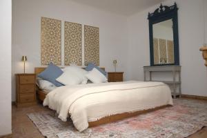 a bedroom with a large bed and a mirror at Pure Gardères in Monlezun +192 photos