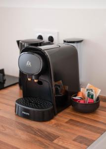 a coffee maker sitting on top of a wooden table at Apartment La casa Zamora in Totana +19 photos
