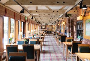 an empty dining car of a train with tables and chairs at Morley Hayes Hotel in Derby